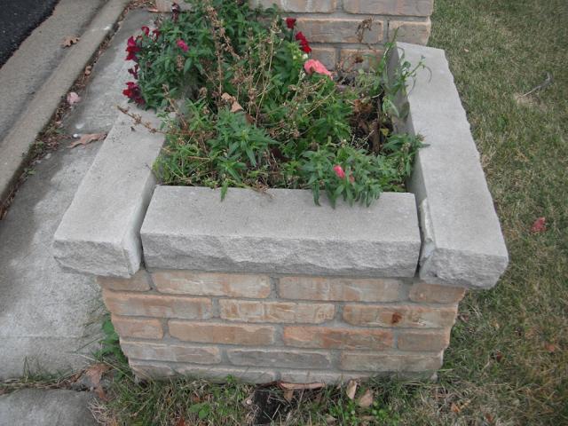 Loose lime stone on the brick mail box planter. (Bolingbrook Home Inspection)