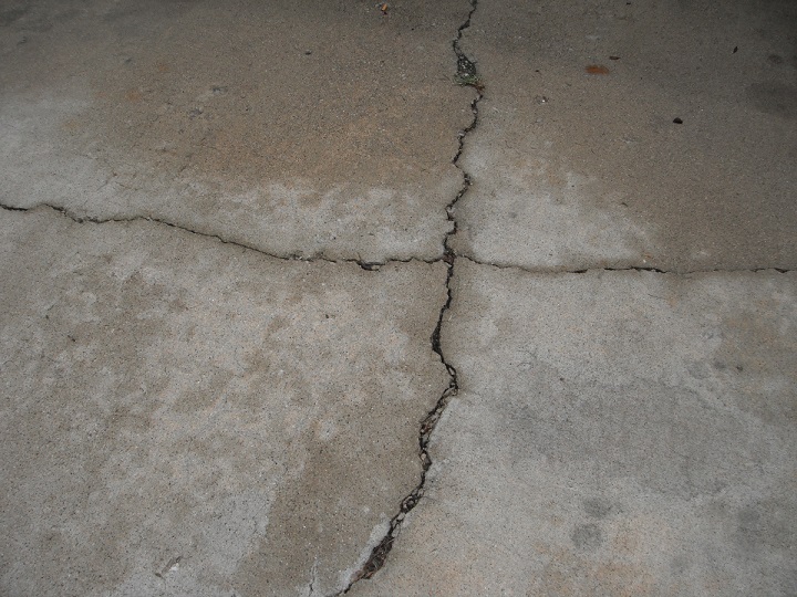 Major cracks on concrete driveway. "Worth Home Inspection Photo" 