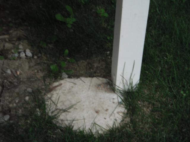 The Support column for the deck barely rests on the concrete footing. "Frankfort Home Inspection"