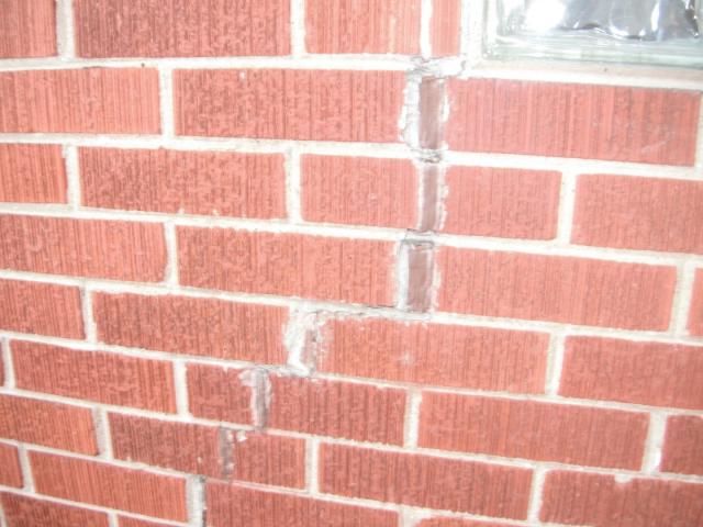Major cracks on the bricks likely caused by a crack on the foundation. "South Holland Home Inspection"