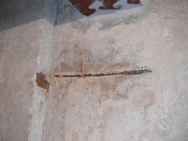 The rebar is exposed and has caused seepage on foundation. Oak Forest Home Inspection Photo"
