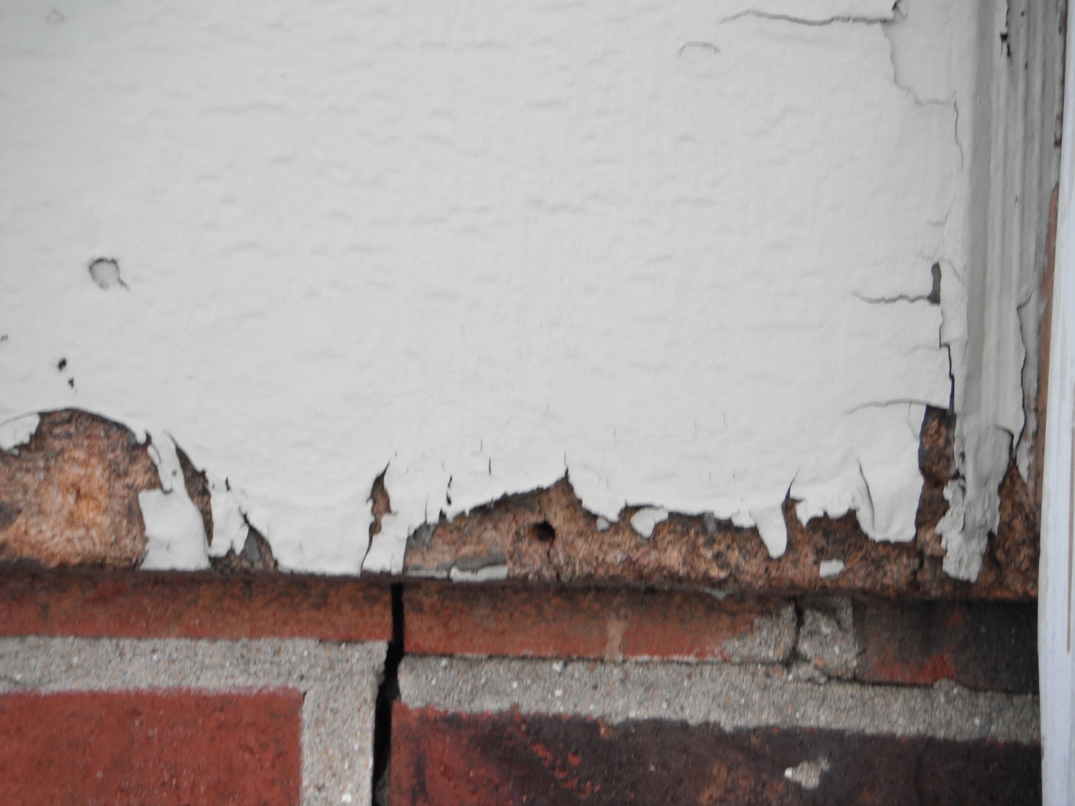 Rotted siding and cracked bricks. (Joliet Home Inspection)