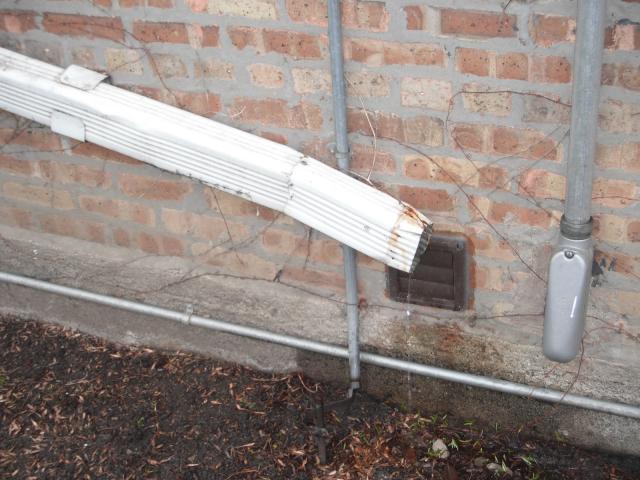 Downspouts end right at the house and also at the exhaust vent cover so water will seep into the house. "Tinley Park Home" 