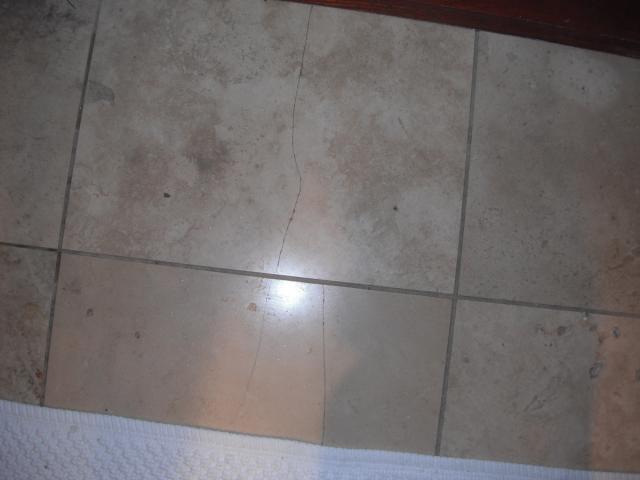 Cracked floor tile. (Forest Park Home Inspection Photo)