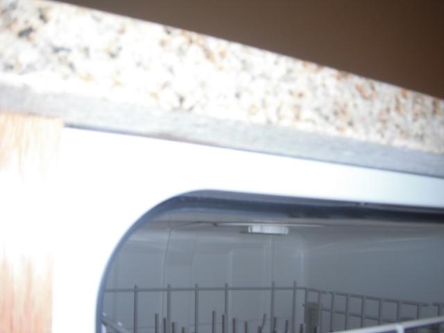 The dishwasher is not properly attached to the counter top. "Lockport Home Inspection Photo"