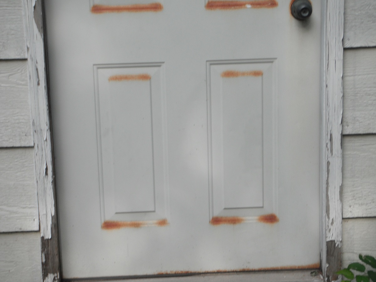 Rusted door and rotted trim and jamb. "Channahon Home Inspector Photo"