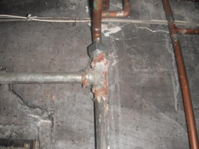 Major corrosion  along with a leak on galvanized pipe. "Homewood Home Inspector Photo"