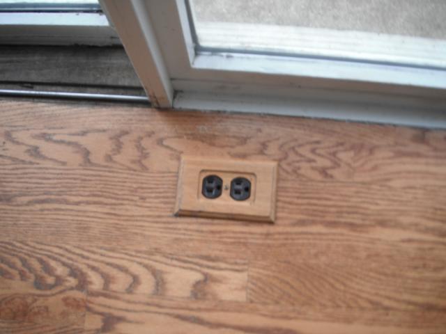 Improper and unsafe electrical floor outlet. "Oak Forest Home Inspection".