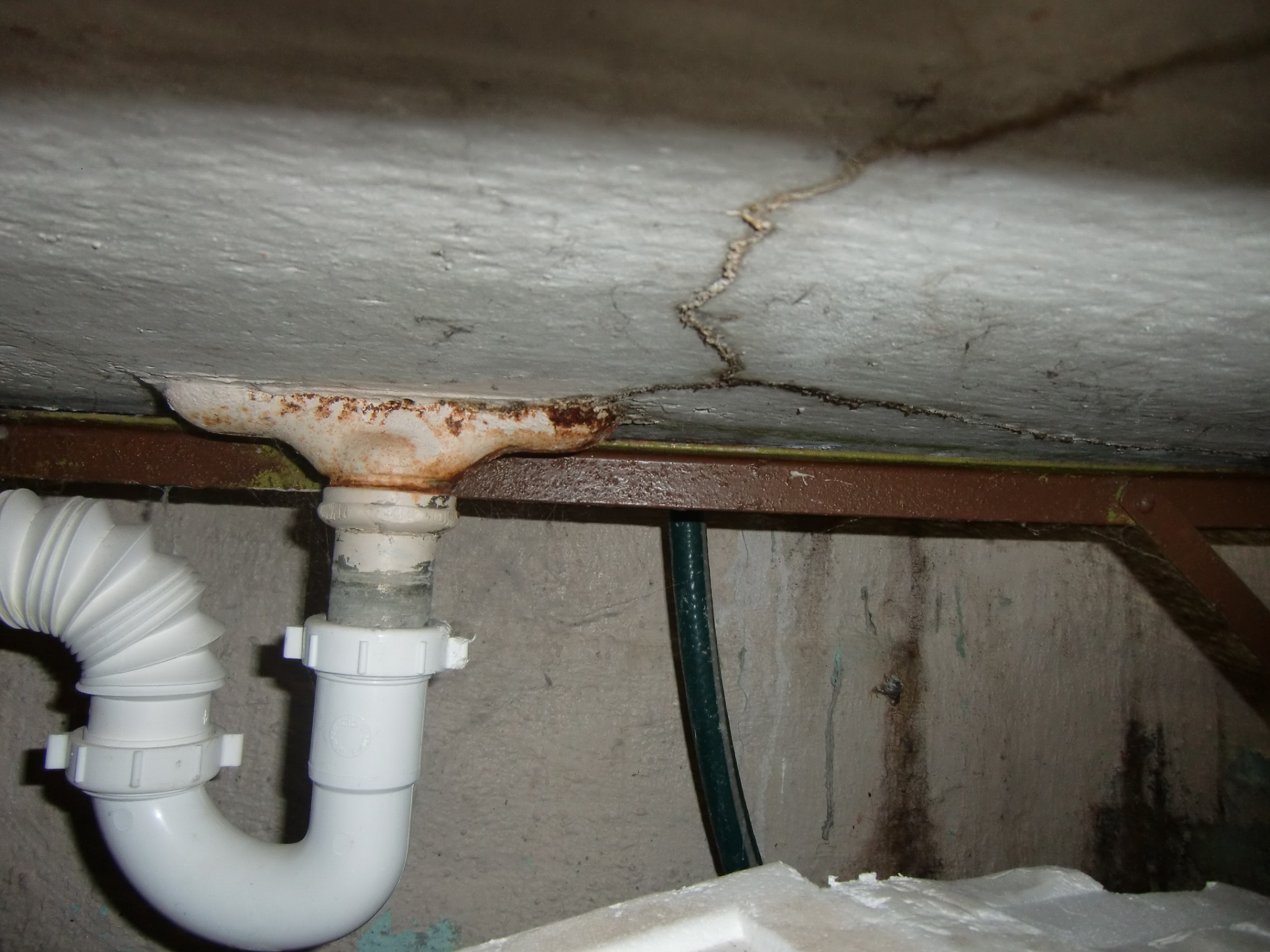A cracked and leaking concrete laundry sink. "Chicago Home Inspection"