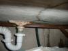 A cracked and leaking concrete laundry sink. "Chicago Home Inspection"
