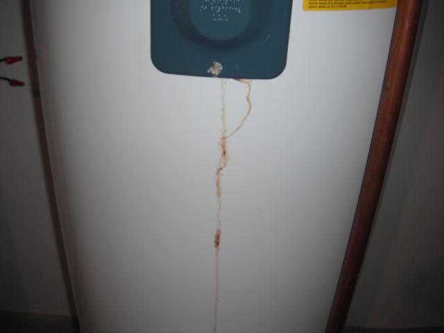 Old leaking water heater needs to be replaced. (Orland Park Home Inspection)