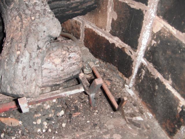 The gas valve is inside the fireplace. This is a safety hazard. "South Holland Home Inspector Photos"