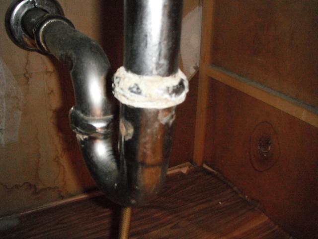 Corroded and leaking sink drian and trap. Needs repalcing. "Orland Hills Home Inspection Photos"