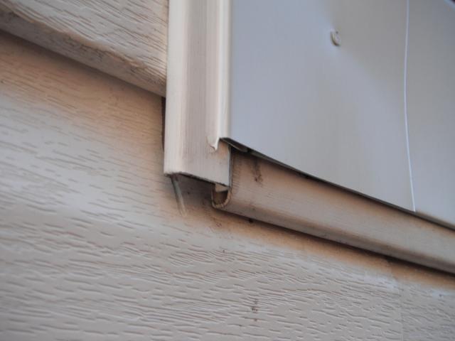 Poorly installed J channel on vinyl siding. (New Lenox Home Inspection Photo)